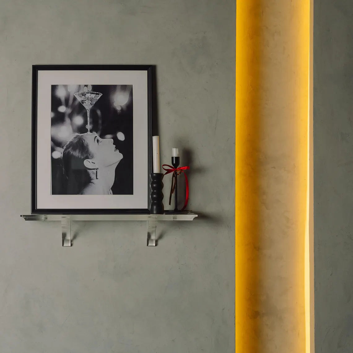 A clear acrylic floating shelf with two mounting brackets
