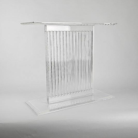 Sculptural acrylic table base with fluted design and reflective surface
