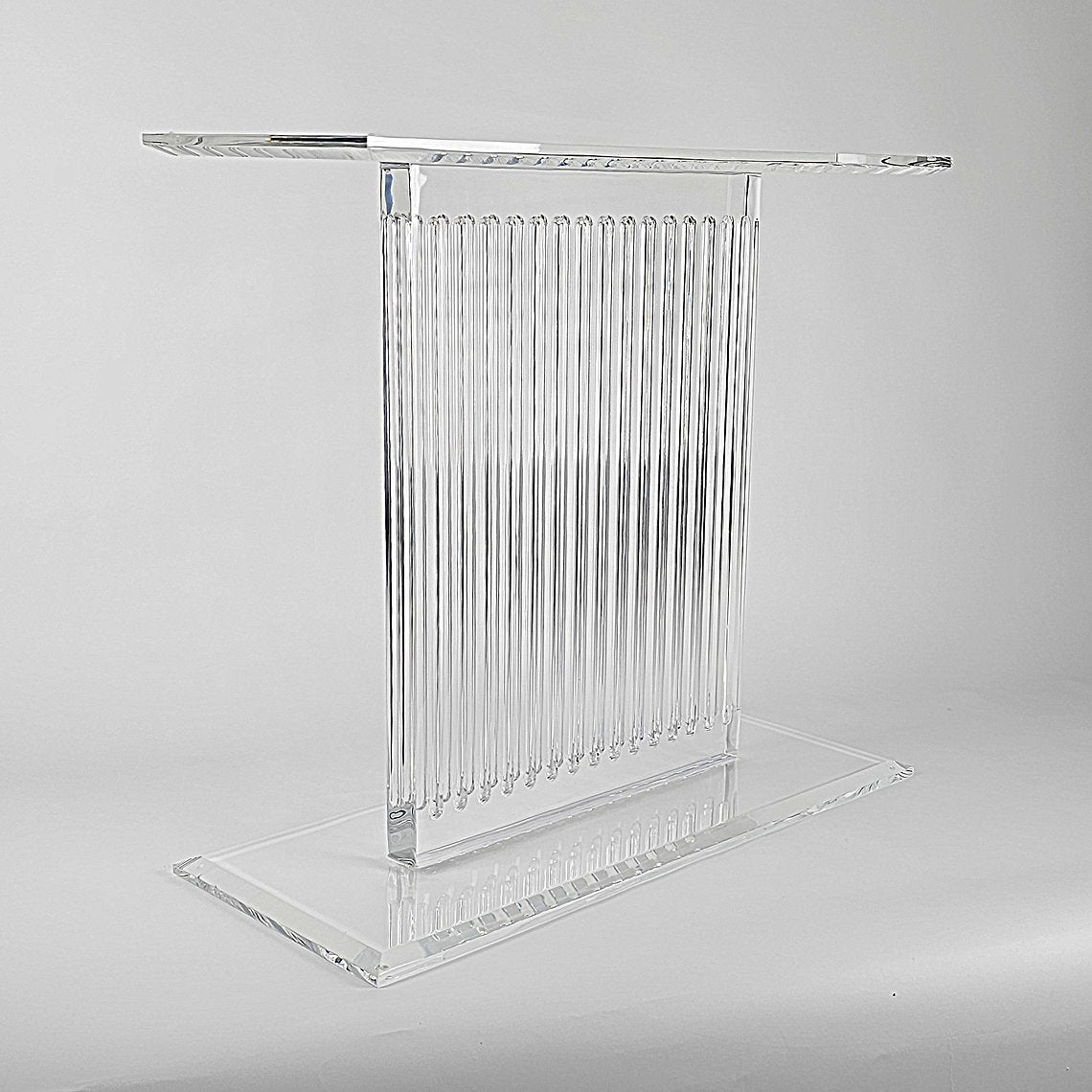 Sculptural acrylic table base with fluted design and reflective surface