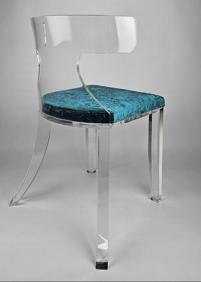 Clear acrylic dining chair with green velvet upholstery