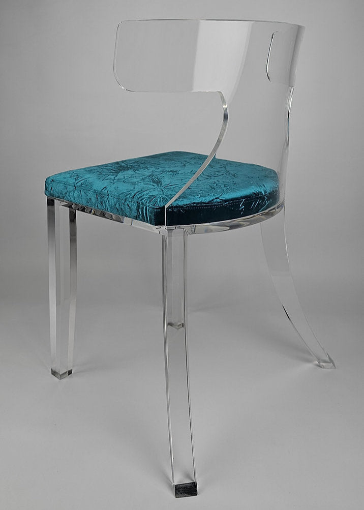 Clear acrylic dining chair with green velvet upholstery