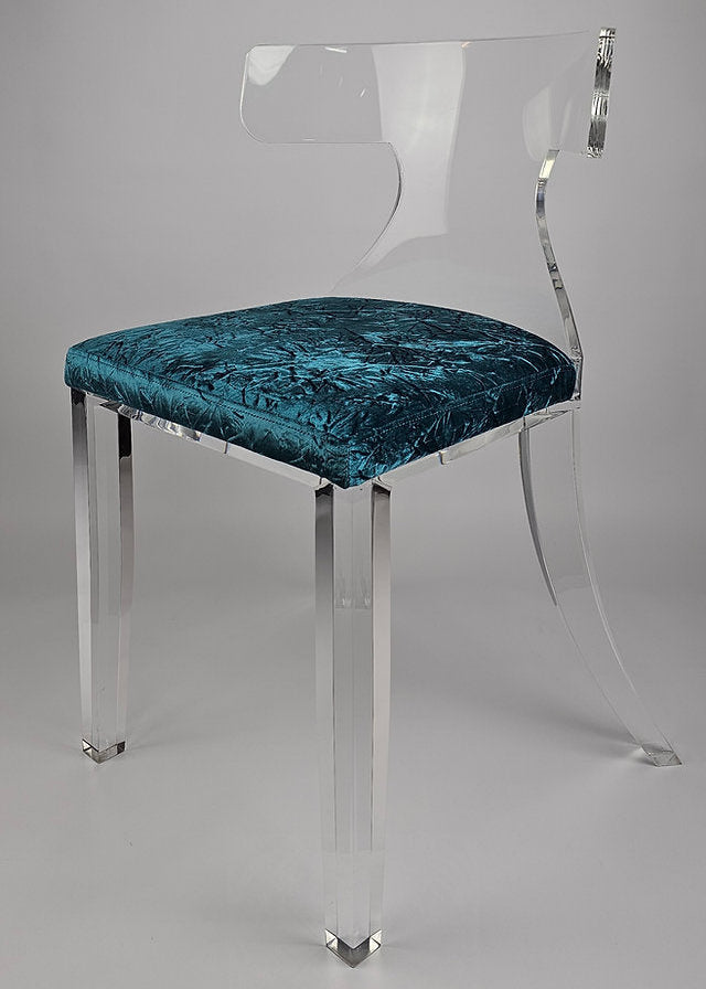 Clear acrylic dining chair with green velvet upholstery