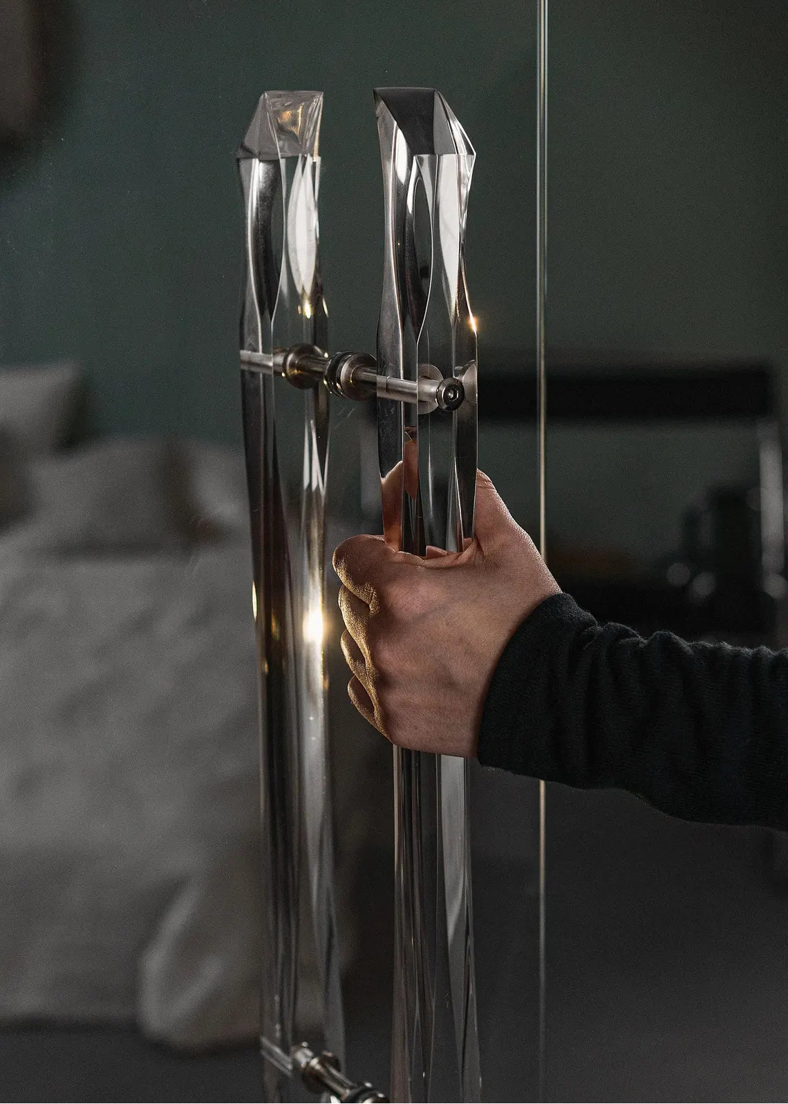 Clear acrylic door pull with flowing edges and chrome or gold accents