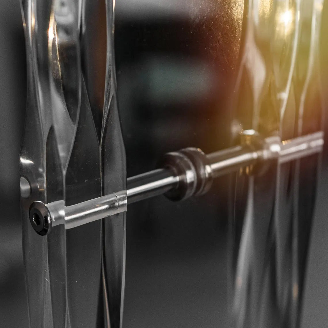 Clear acrylic door pull with flowing edges and chrome or gold accents