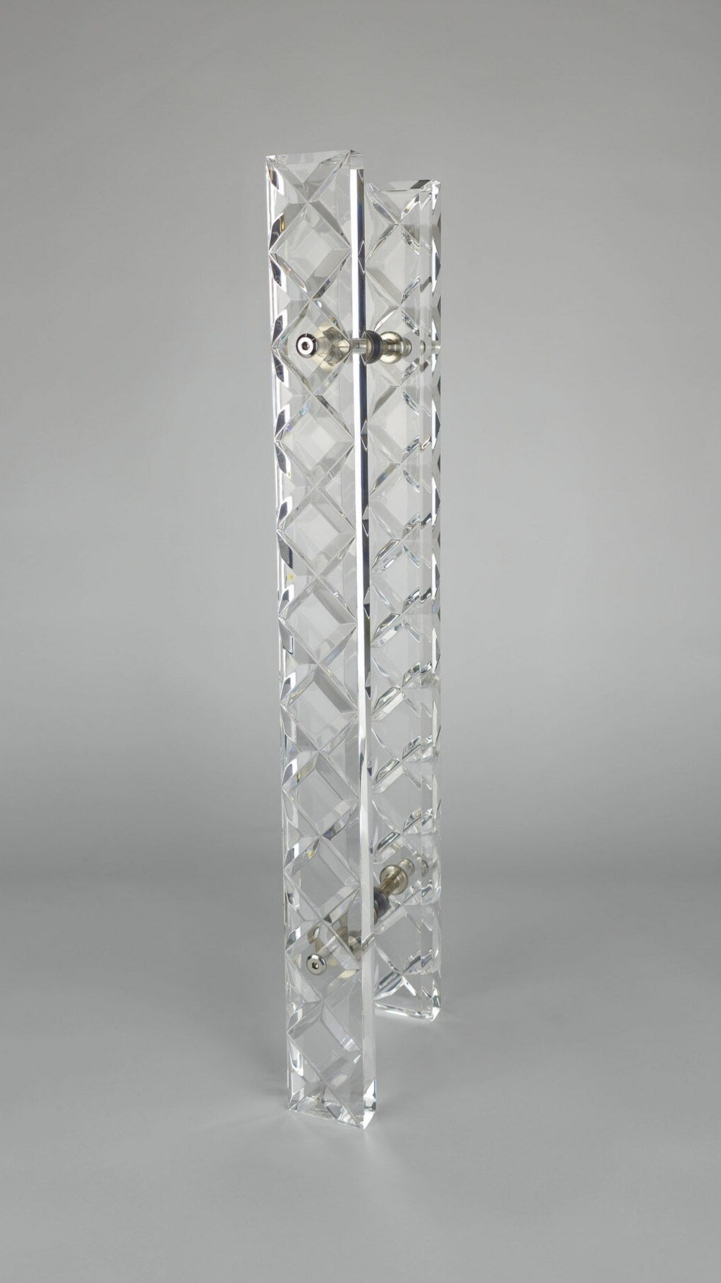 Clear acrylic door pull with a criss-cross pattern and chrome or gold accents