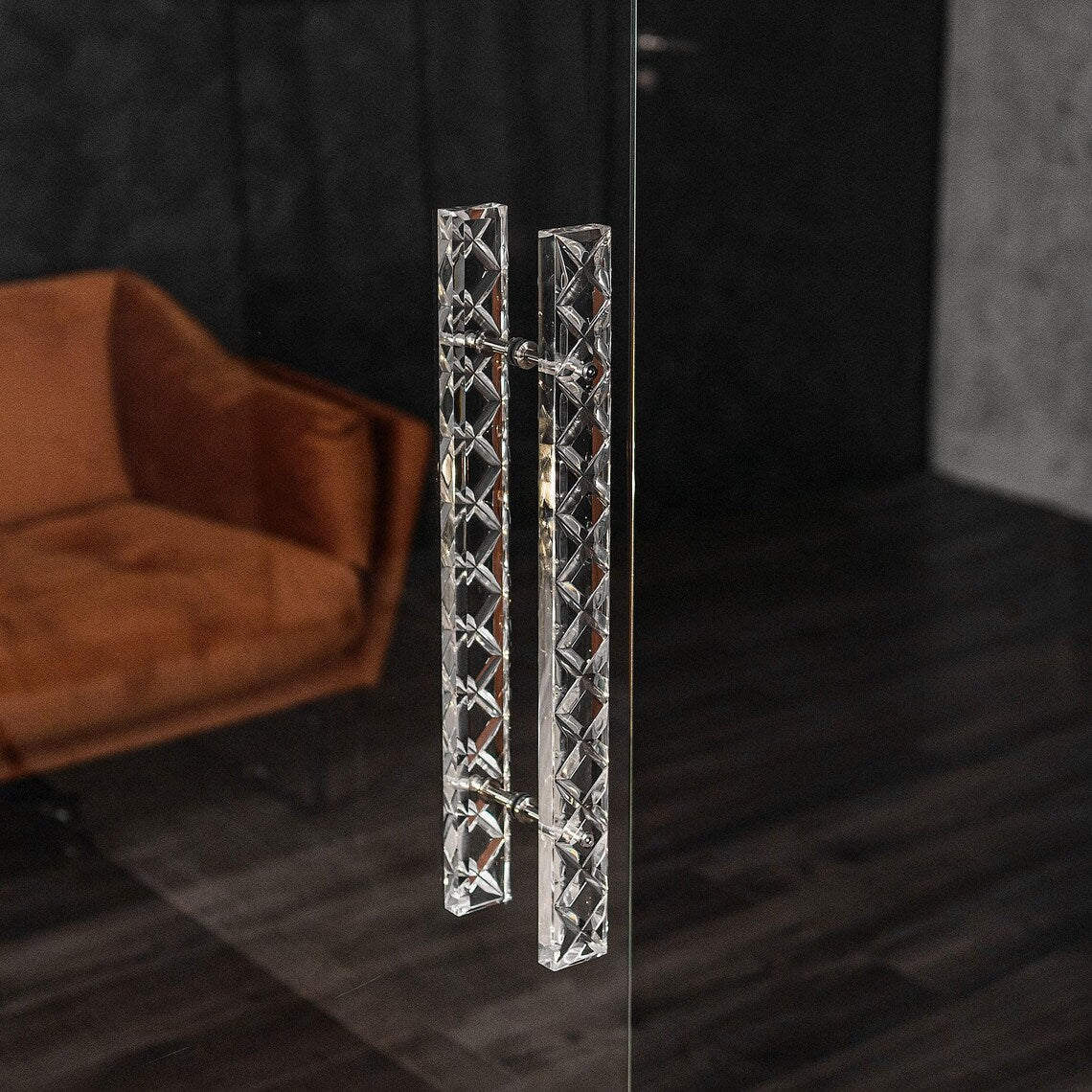 Clear acrylic door pull with a criss-cross pattern and chrome or gold accents