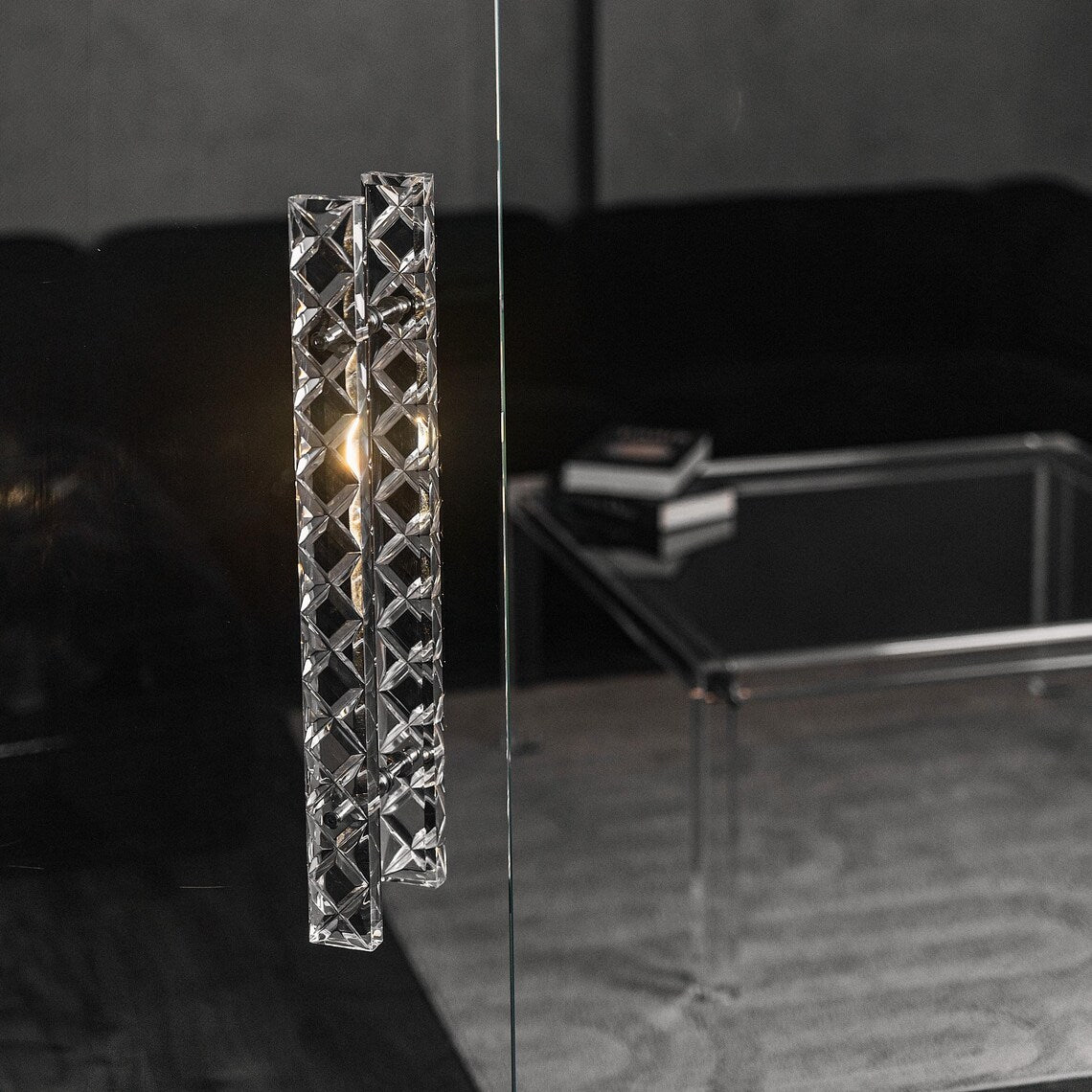 Clear acrylic door pull with a criss-cross pattern and chrome or gold accents