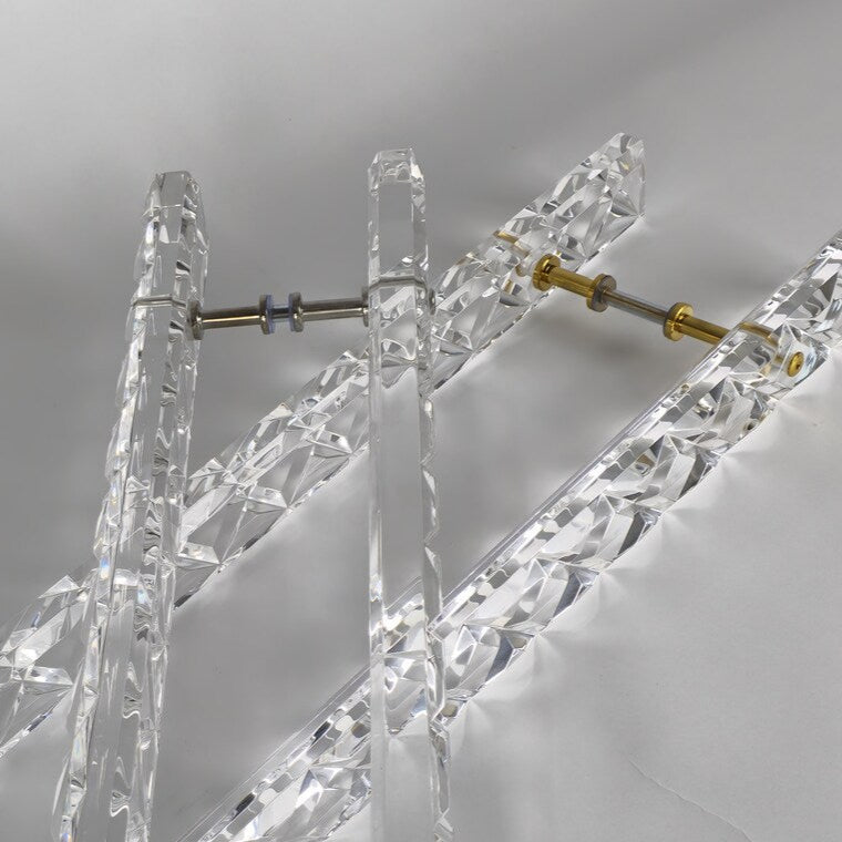 Clear acrylic door pull with a criss-cross pattern and chrome or gold accents