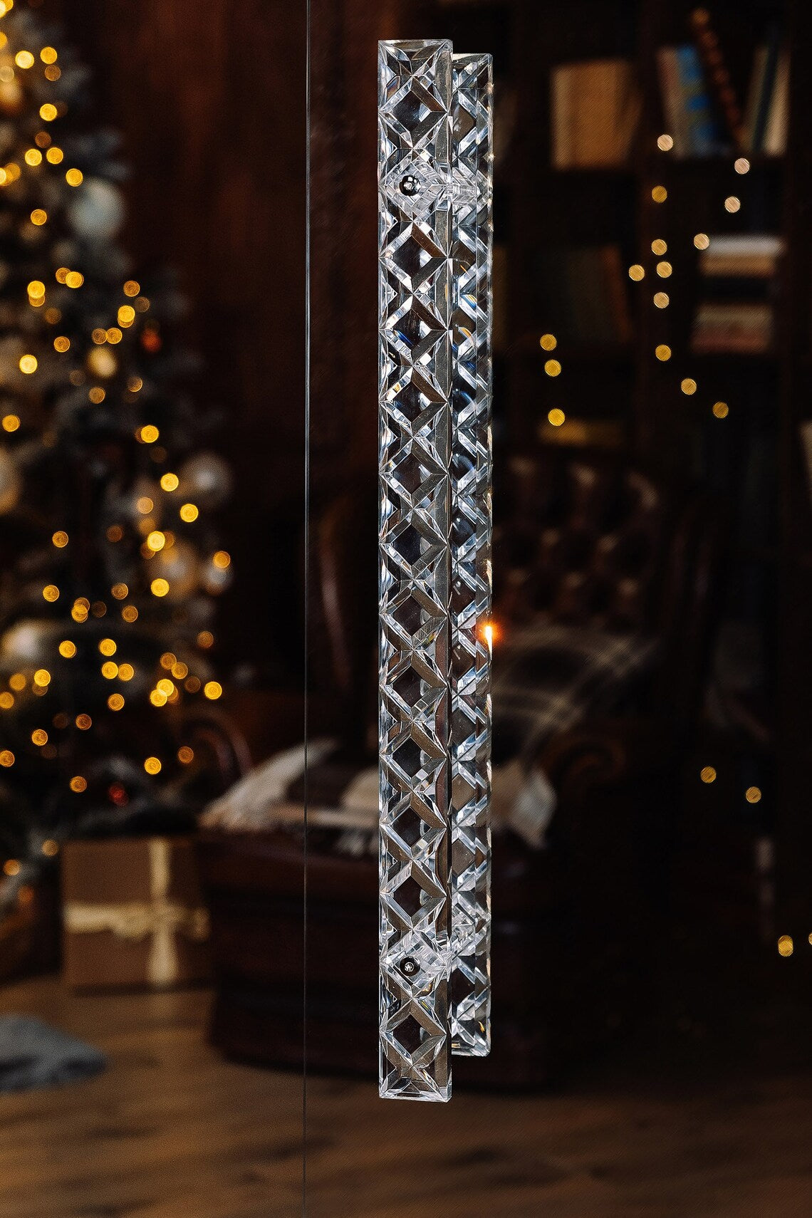 Clear acrylic door pull with a criss-cross pattern and chrome or gold accents