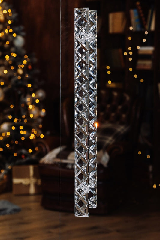 Clear acrylic door pull with a criss-cross pattern and chrome or gold accents