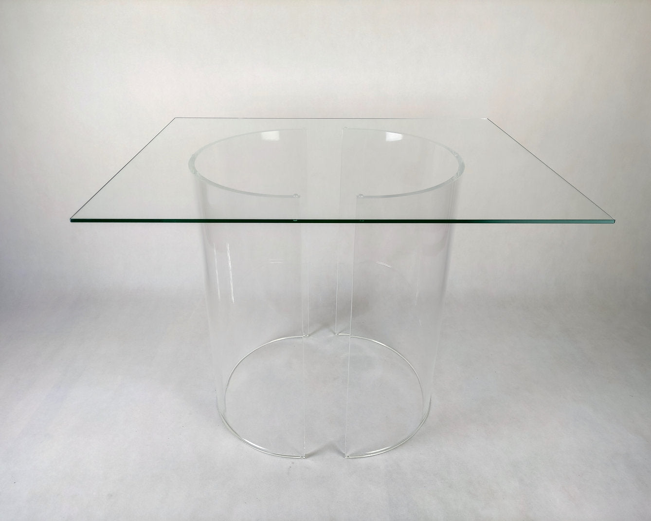 Clear acrylic table base with a c-shaped cross section