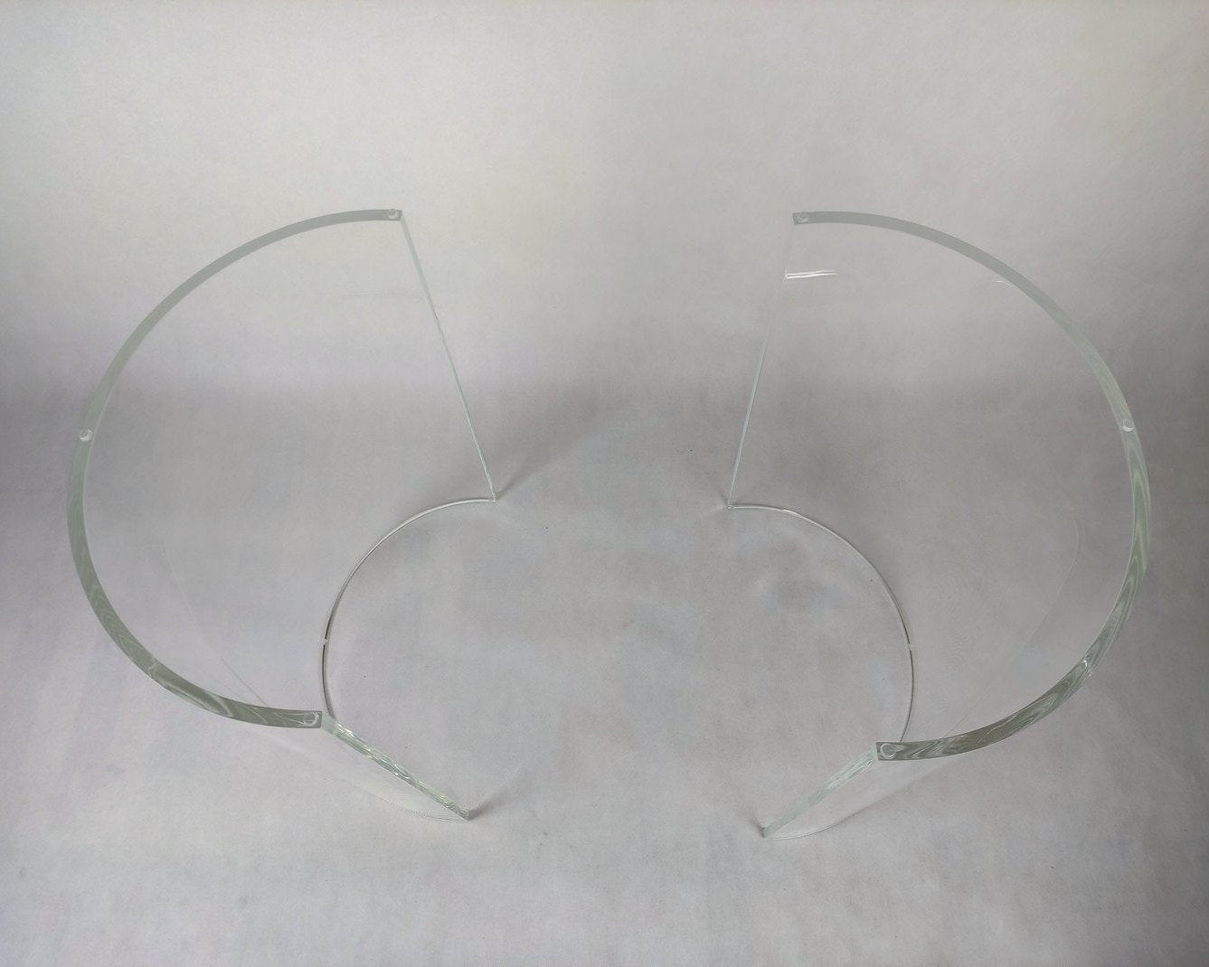 Clear acrylic table base with a c-shaped cross section