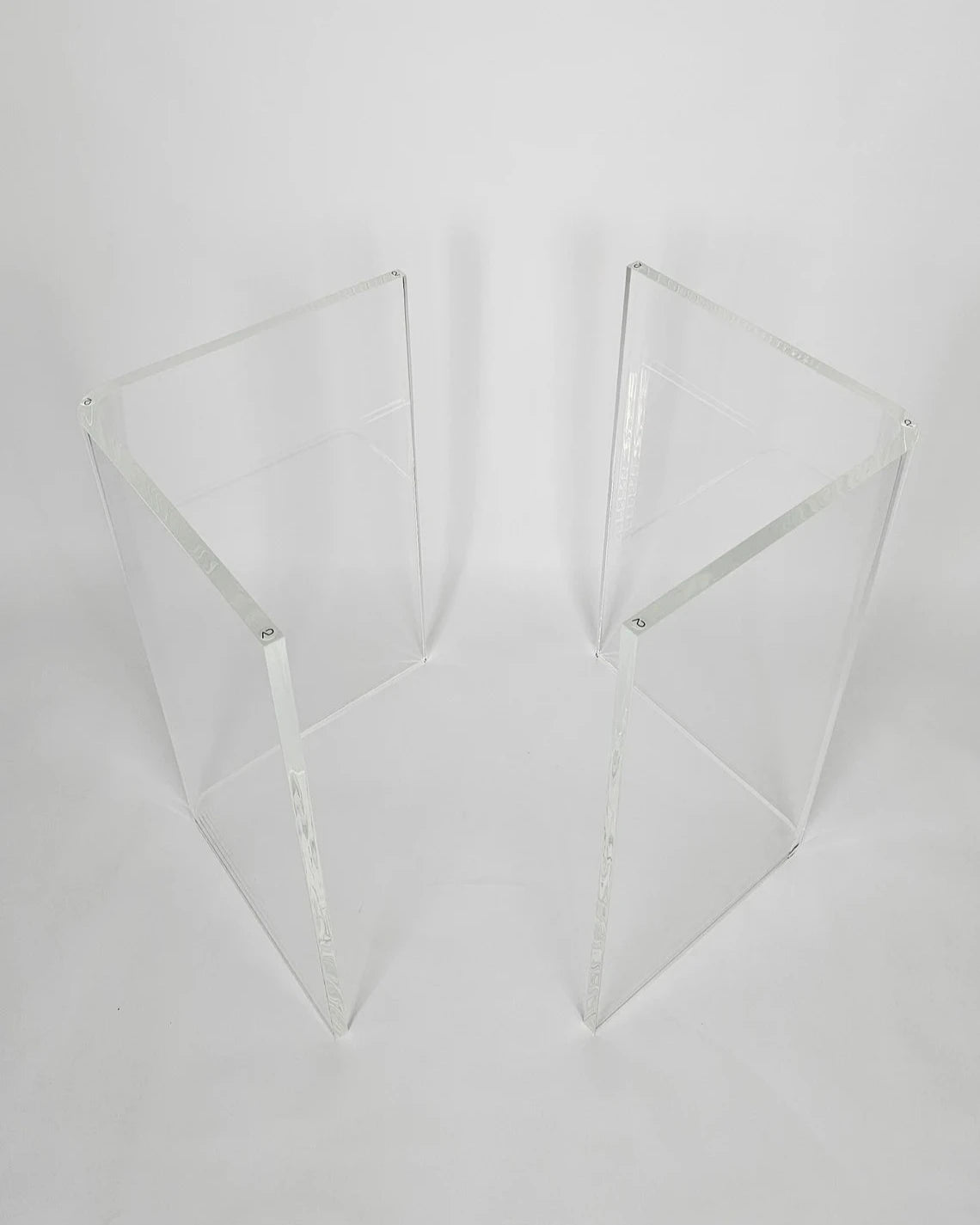 Clear acrylic table base with a v-shaped cross section