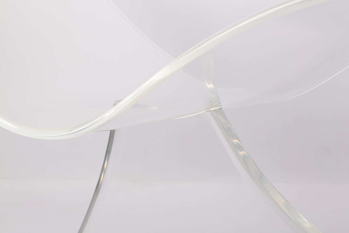 Clear acrylic lounge chair with a wavy profile