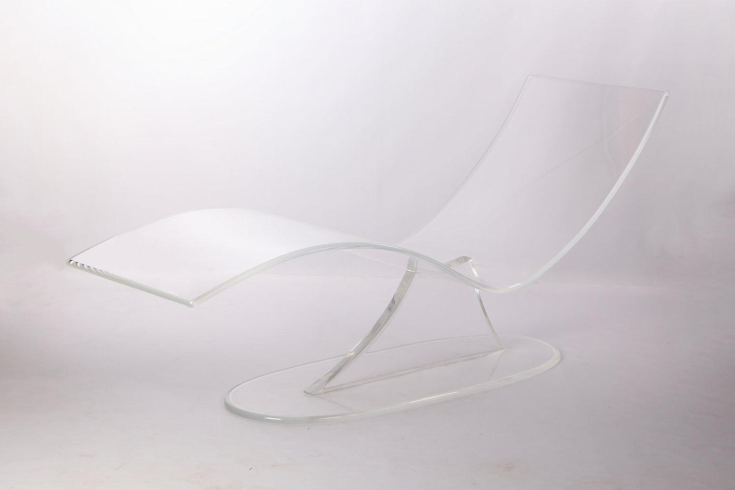 Clear acrylic lounge chair with a wavy profile