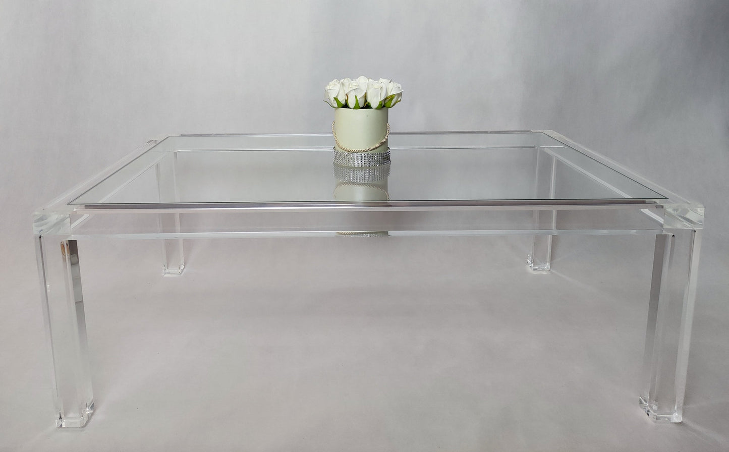 Clear acrylic coffee table with a minimalist rectangular style