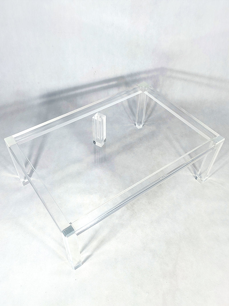 Clear acrylic coffee table with a minimalist rectangular style