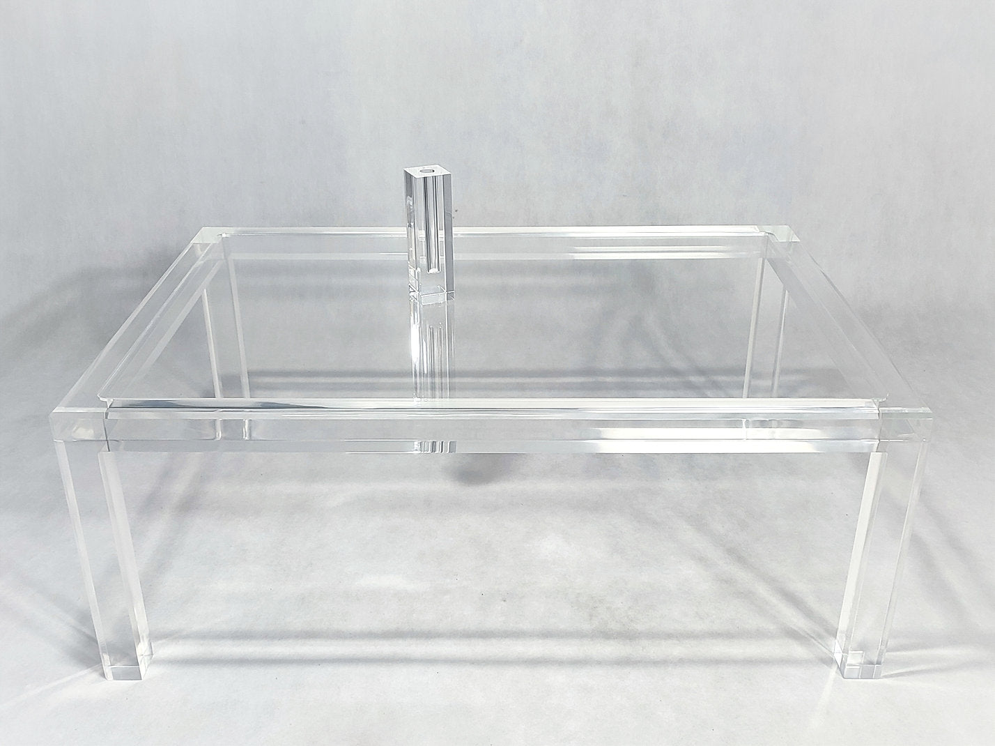 Clear acrylic coffee table with a minimalist rectangular style
