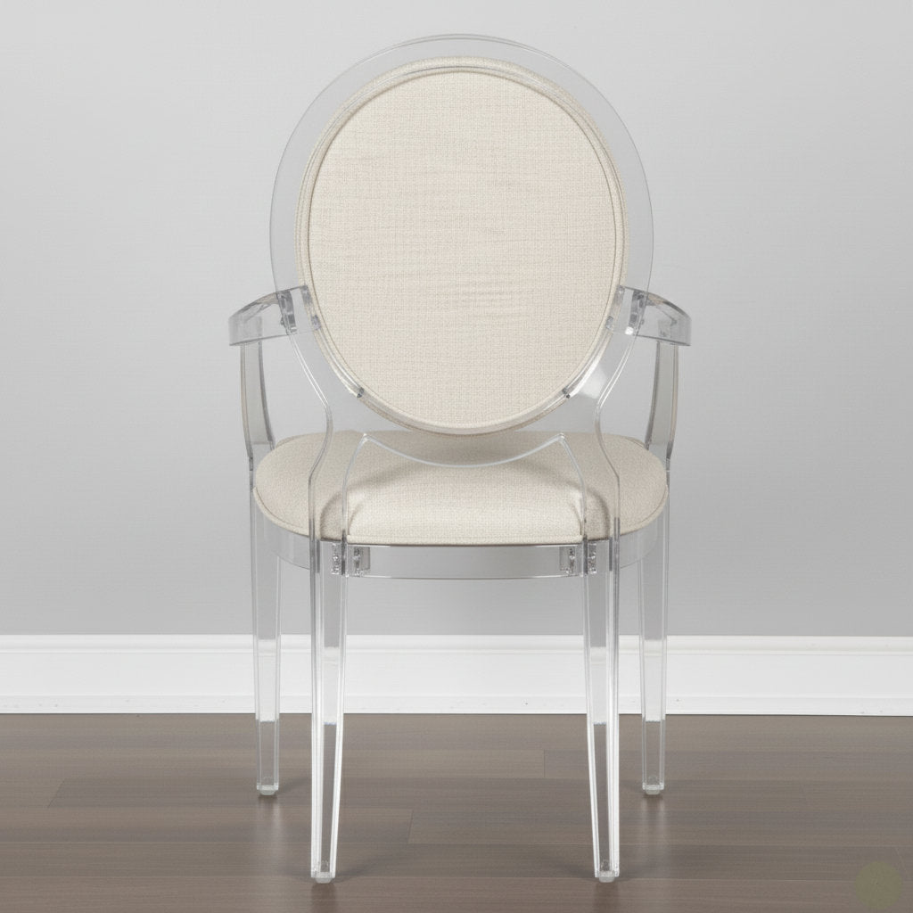 Clear acrylic chair with beige cushioned seat and backrest against a gray wall.