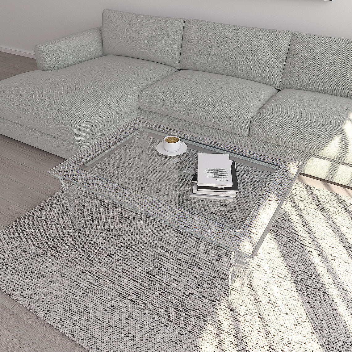 Gray sectional sofa with a clear acrylic coffee table in a living room setting