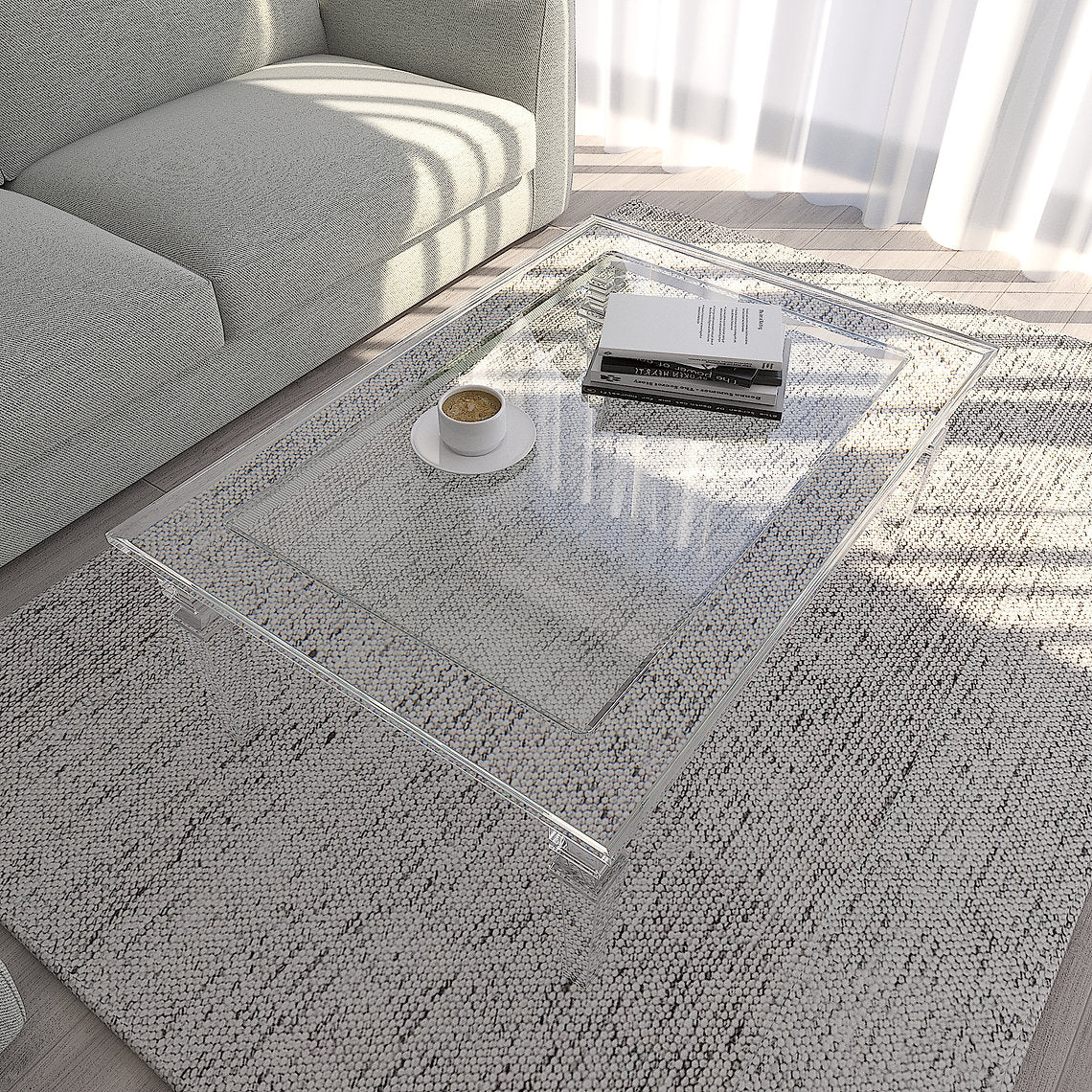 Clear acrylic coffee table in a living room with a sofa and decor items.