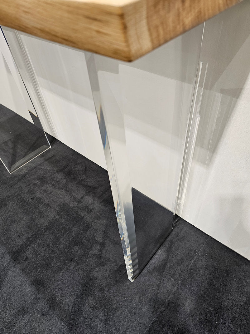 Clear acrylic console table with a light wood top