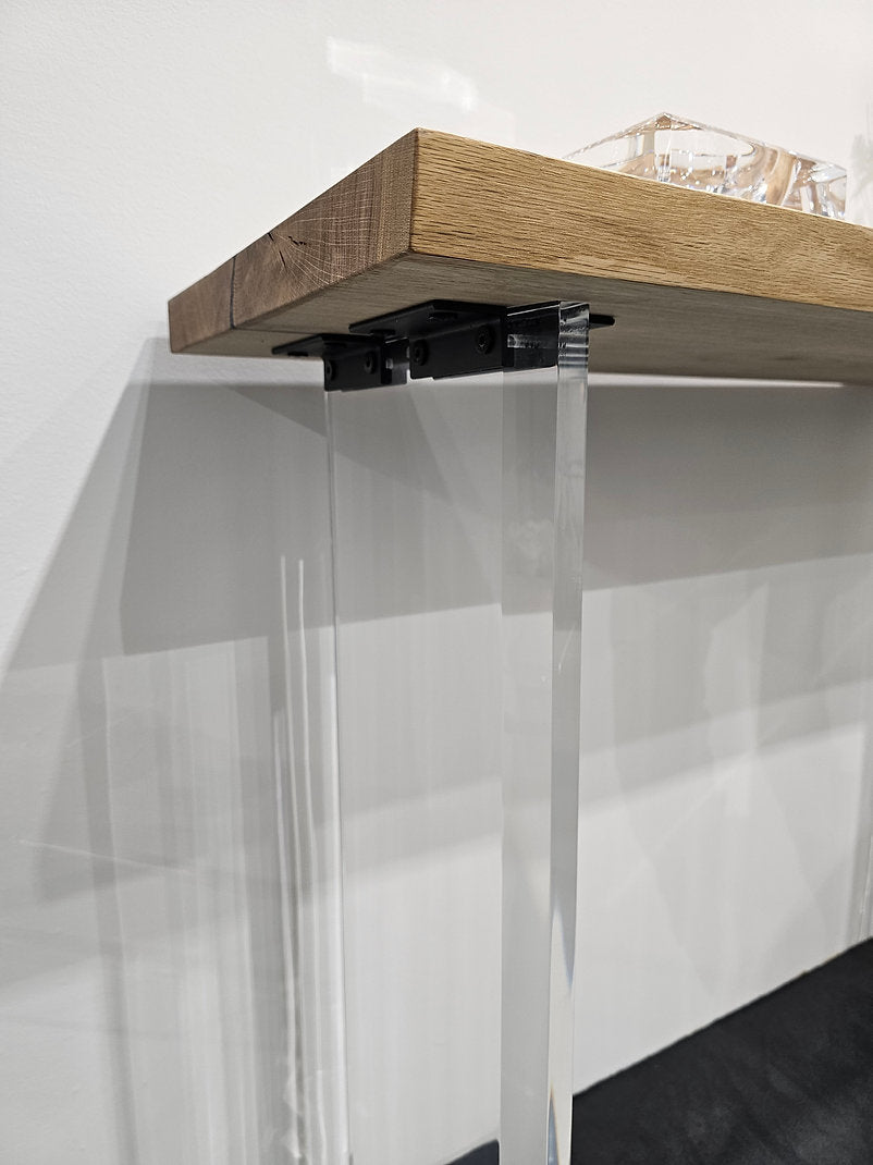 Clear acrylic console table with a light wood top