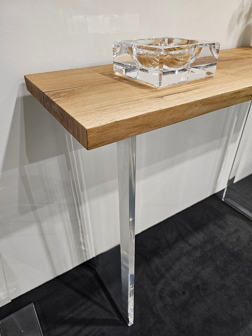 Clear acrylic console table with a light wood top